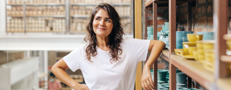 Female small business owner thinking about international payment methods.